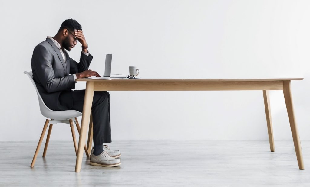 Side,view,of,young,black,office,employee,feeling,tired,of